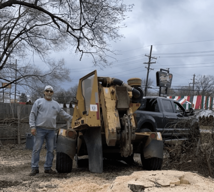 A man standing next to an old truck.